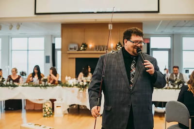 Wedding emcee speaking at the head table during a Manitoba reception
